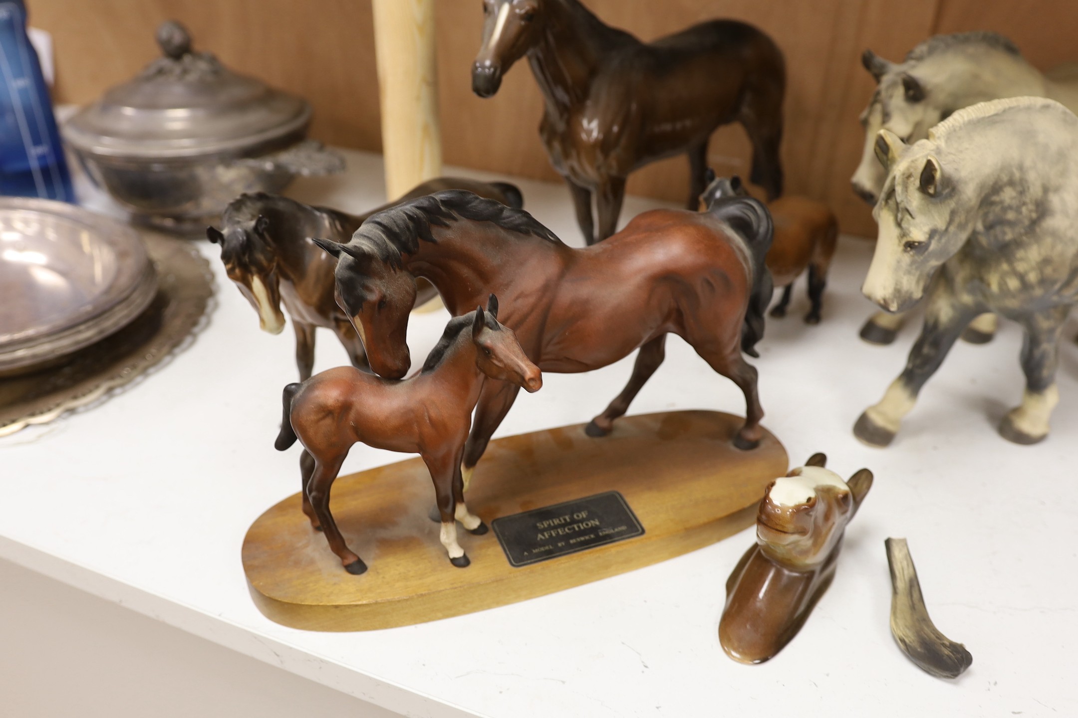 A collection three single Beswick horses, a group figure of a mother and foal, a wall pocket and two Lenham pottery shire horses, tallest 28 cm